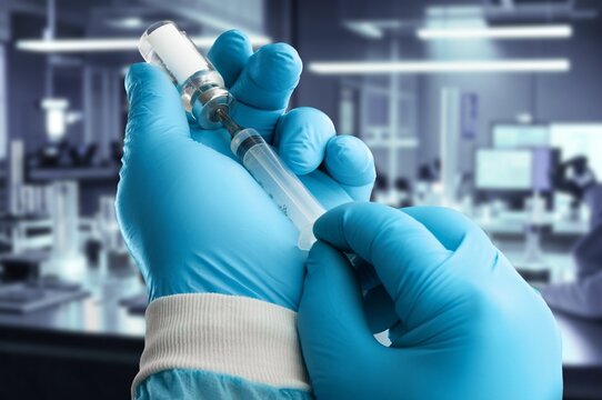 vaccine in a vial in hands, treatment of infection