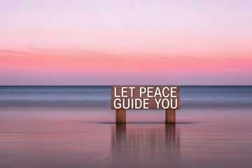 Wooden sign with message on beach at sunset