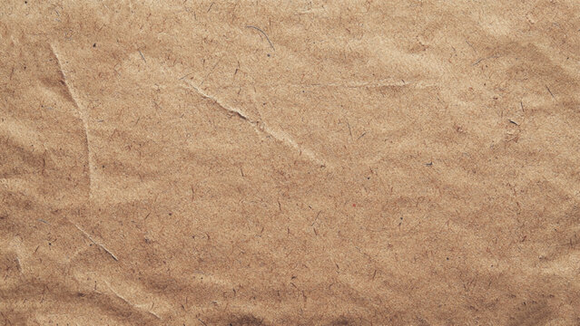 Background of brown kraft paper or cardboard texture. Abstract pattern of beige rough carton, old paper sheet. Old brown vintage paper texture background