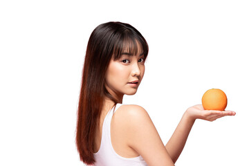 Asian Young woman holding orange fruit in open palm, healthy skin, long hair, studio portrait,...