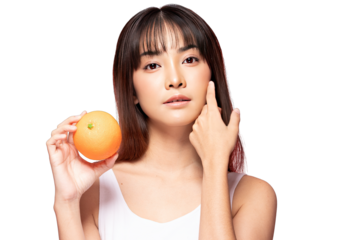 Asian Young woman holding orange near face with clear skin and natural makeup, skincare concept with fresh fruit and soft expression