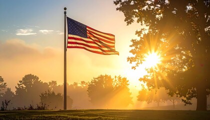 American flag waving on flagpole during sunrise with golden light misty trees and serene atmosphere for editorial patriotic photography commemorative design and poetic heritage-themed visuals