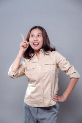 Surprised Asian Woman Pointing Up with Bright Expression