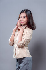 Charming Asian Woman Smiling with Hands Near Face