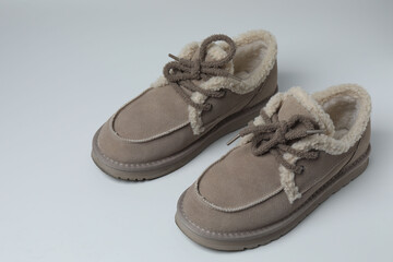 A pair of new women's short boots with medium-high heels on a gray background, studio shot.
