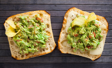 morning toast with melted cheese and guacamole. top view