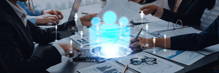 Business team collaborating with digital technology visualization, analysis, and data management in modern office Trope.