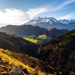 Majestic mountains, lush valley, and winding roads, a sunny vista