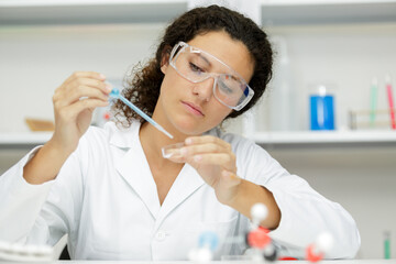 a woman with a pipette and tube