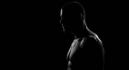 Silhouette of a Muscular Man in Dramatic Lighting