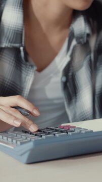 Vertical Screen : Stress asia couple man woman use calculator for calculate family budget, debts, monthly expenses during financial economic crisis at home. Marriage money trouble budget plan concept.