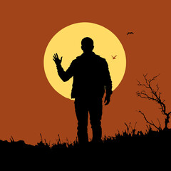 Silhouette of a man standing in the desert during sunset with warm orange sky and peaceful landscape