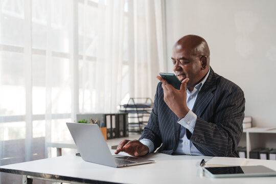 African businessman using smartphone for voice message