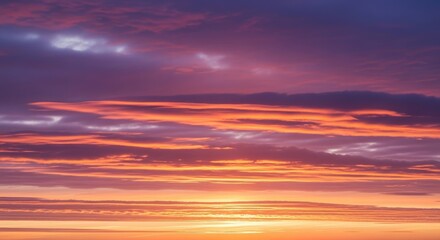 Vibrant sunset with orange and purple clouds streaking across the sky