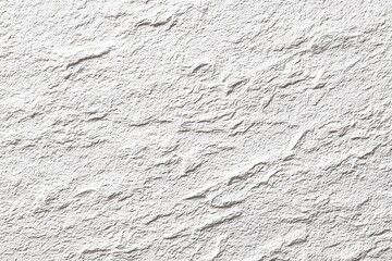 Textured, light gray stucco or stone wall surface