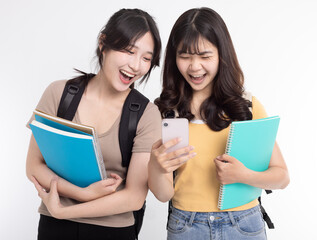 Happy Asian female students watching the smart phone