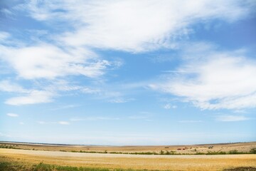 Fototapeta premium Beautiful hilly landscape in the foreground with blue sky