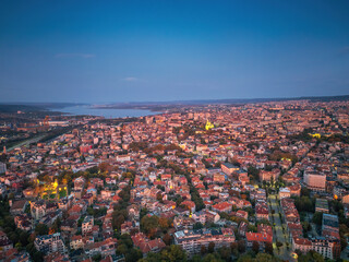Scenic panoramic city view of Varna, Bulgaria cityscape, aerial drone view over the city skyline during dramatic sunrise