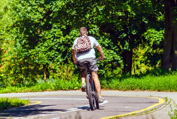 Fototapeta premium Cyclist ride on the bike path in the city Park 