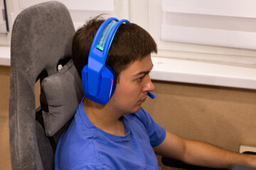 Digital meditation concept - gamer achieves flow state during intense gameplay. Blue headphones...