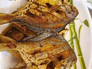 Crispy Fried Small White Pomfret Served on Plate