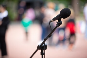 Microphones in focus, people in background conference