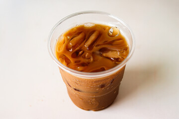 Iced coffee in glass cup on white table