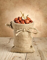 Rustic Burlap Sack Overflowing with Hazelnuts on Wooden Table.