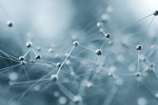 Close-up of connected silver spheres and lines, set against a blurred, blue background
