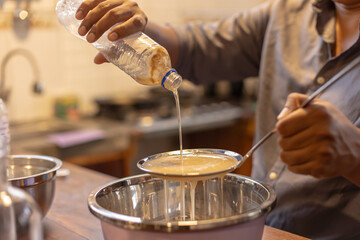 Medicinal honey from the Amazonian stingless bee Melipona eburnia, cultivated by native Amazonians of Peru, during the process of filtering and packaging the honey in glass containers