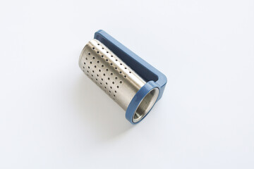 A modern tea strainer positioned on a clean white background. The stainless steel mesh cylinder with numerous small holes is visible, highlighting the functional design of this tool.