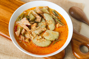 Top view of Lontong Sayur, a traditional Indonesian dish featuring compressed rice cakes (lontong) served in a rich and spicy coconut milk broth with various vegetables.