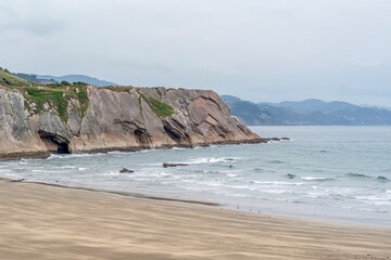 Layered Flysch Rock Formation Cliffs and Wide Sandy Beach on the Basque Coast Spain; Bay of Biscay