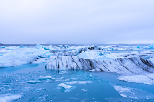Glacial lagoon filled with floating icebergs in iceland - Powered by Adobe