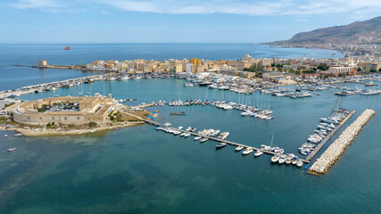 Aerial view of Trapani, Sicily, Italy. It is a Sicilian city with a port overlooking the Mediterranean Sea. Mount Erice dominates the town in the background.