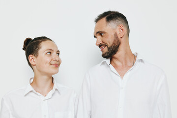 A professional man in business attire shares a warm smile with a colleague on an isolated white background, conveying teamwork, confidence, and approachable leadership.