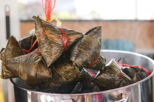 Steaming wrapped Zongzi (Sticky rice dumpling or Bacang) tied with colorful strings, freshly cooked in preparation for the upcoming Dragon Boat Festival, also known as Duanwu or the Zongzi Festival. 