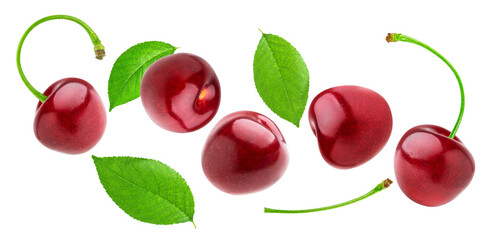 glossy, loose red cherries and scattered fresh green leaves captured mid-air, generating a vibrant, dynamic floating composition isolated on black.