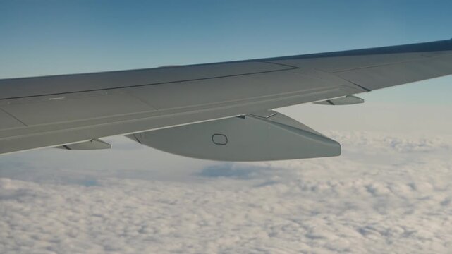 airplane window seat view of the wing and flaps