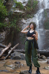 Woman hiking in nature admiring natural waterfall
