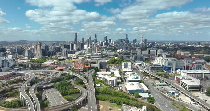 4K Aerial Push In forward Tracking  view of the Inner City Bypass and interchange motorway with the Brisbane City Central Business district buildings in the background, Brisbane, Queensland, Australia