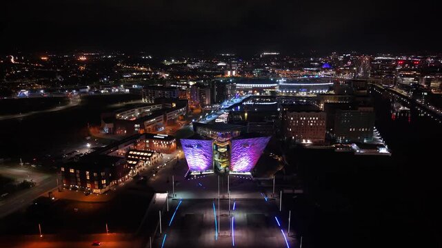 Overhead reversing 4K 60FPS aerial of Titanic Belfast and the surrounding area at night. Produced in Northern Ireland with Rec709 color profile.