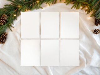 Christmas Mockup with Six Blank Cards, Pine Cones and Fir Branches on White Fabric