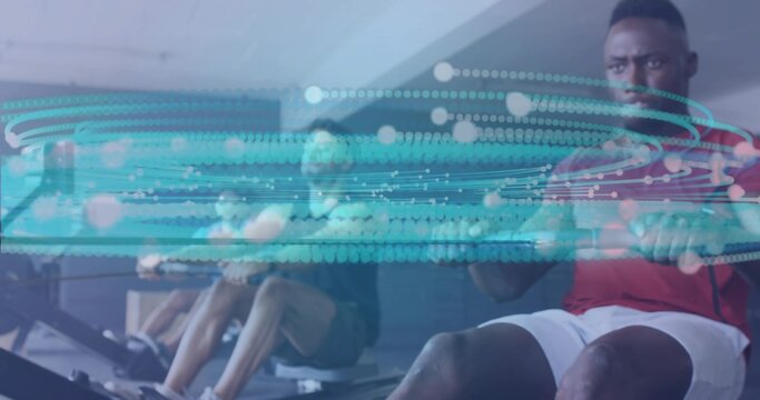 Pulling rowing handle, adult male using rowing machine in gym, with digital overlay, copy space - Powered by Adobe