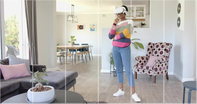 Exploring virtual reality wearing VR headset and striped sweater in living room, with bonsai plant - Powered by Adobe