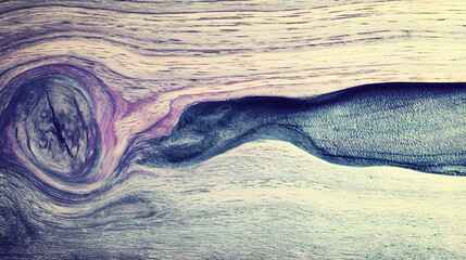 An artistic view of a unique wooden texture with swirling patterns in hues of blue and purple.