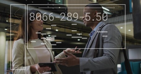 Colleagues in business attire discussing in lobby with tablet, shoulder bag and holographic overlay