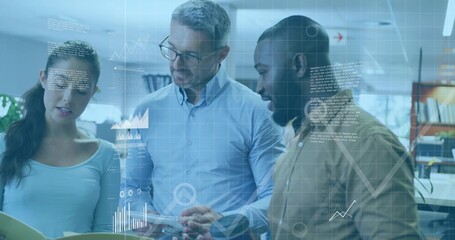 Team analyzing printed notes and data in open plan office, with yellow folder, floating charts