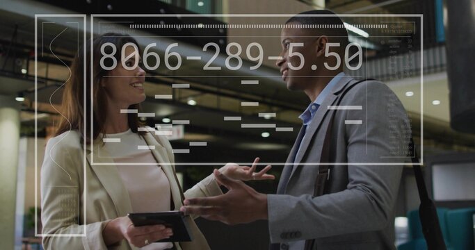 Colleagues in business attire discussing in lobby with tablet, shoulder bag and holographic overlay