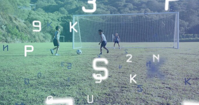 Running three boys dribbling soccer ball toward goal on pitch in uniform, floating digital overlays